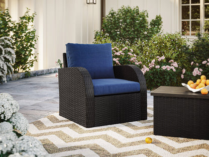 Blue outdoor wicker patio chair with cushions and durable frame.