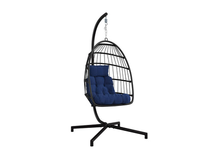 Hanging egg chair in blue with cushioned seat, wicker frame, and sturdy metal stand for patio or garden use.