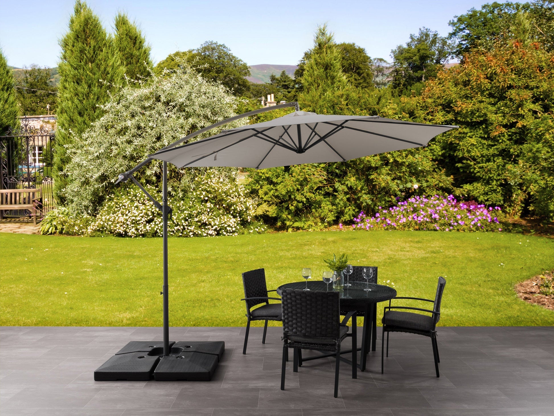 Grey 9.5ft tilting offset patio umbrella with durable fabric, adjustable canopy, and sturdy metal frame.