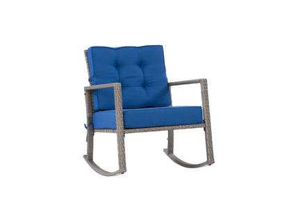 Grey and blue wicker outdoor rocking chair with cushioned seat and back, perfect for patio relaxation.