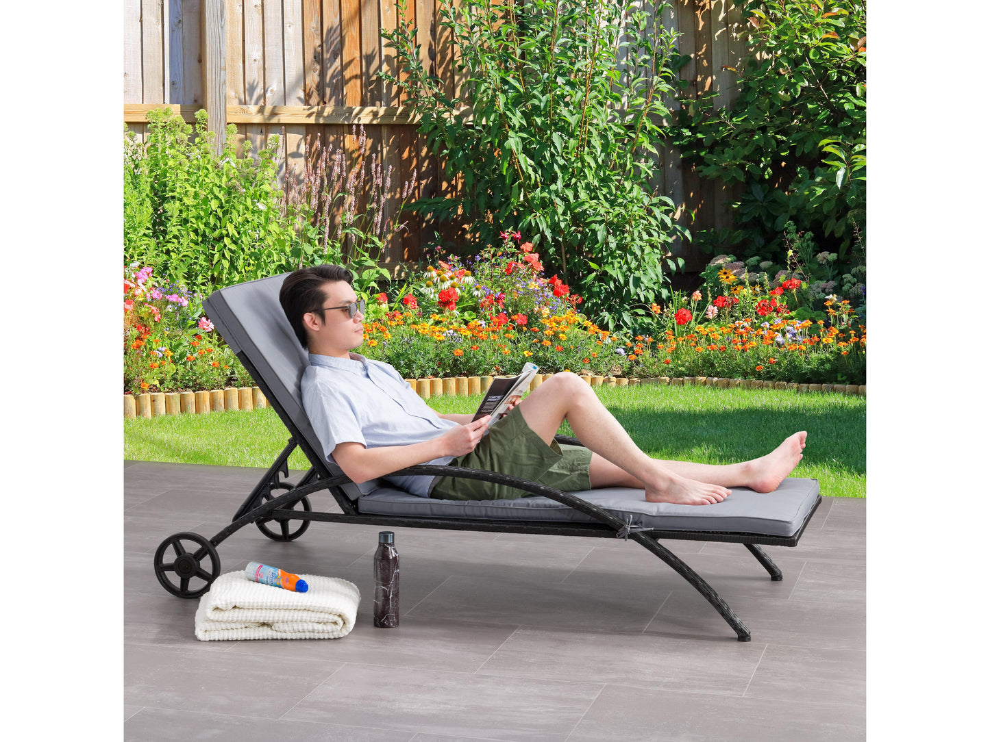 Outdoor wicker lounge chair in black and grey with cushioned seat, perfect for patio relaxation