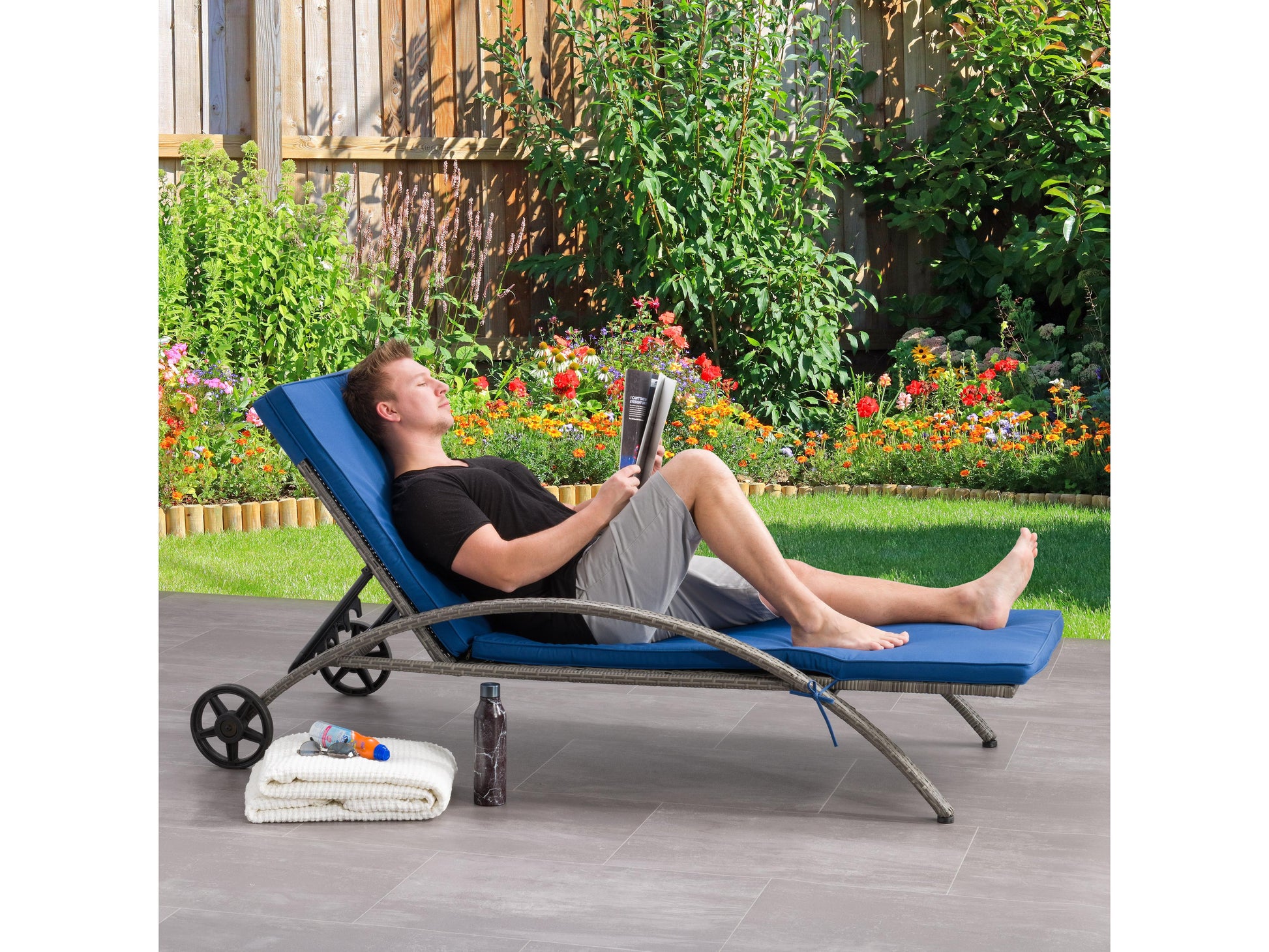 Grey and blue outdoor wicker lounge chair with cushioned seat and backrest, featuring a durable frame and weather-resistant design.