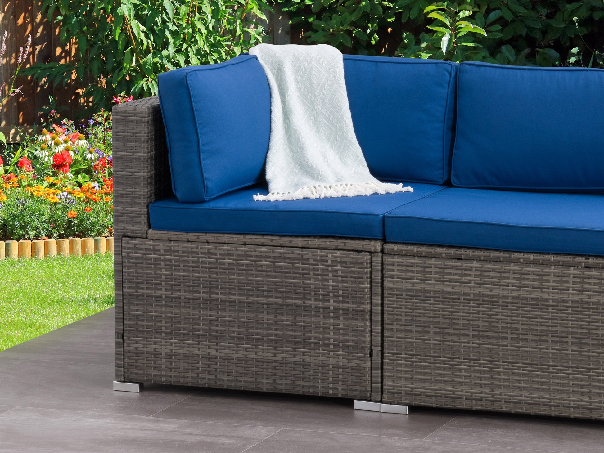 Modern outdoor corner patio chair with gray cushions, dark brown wicker frame, and aluminum legs, featuring a sleek, minimalist design perfect for garden or patio seating.