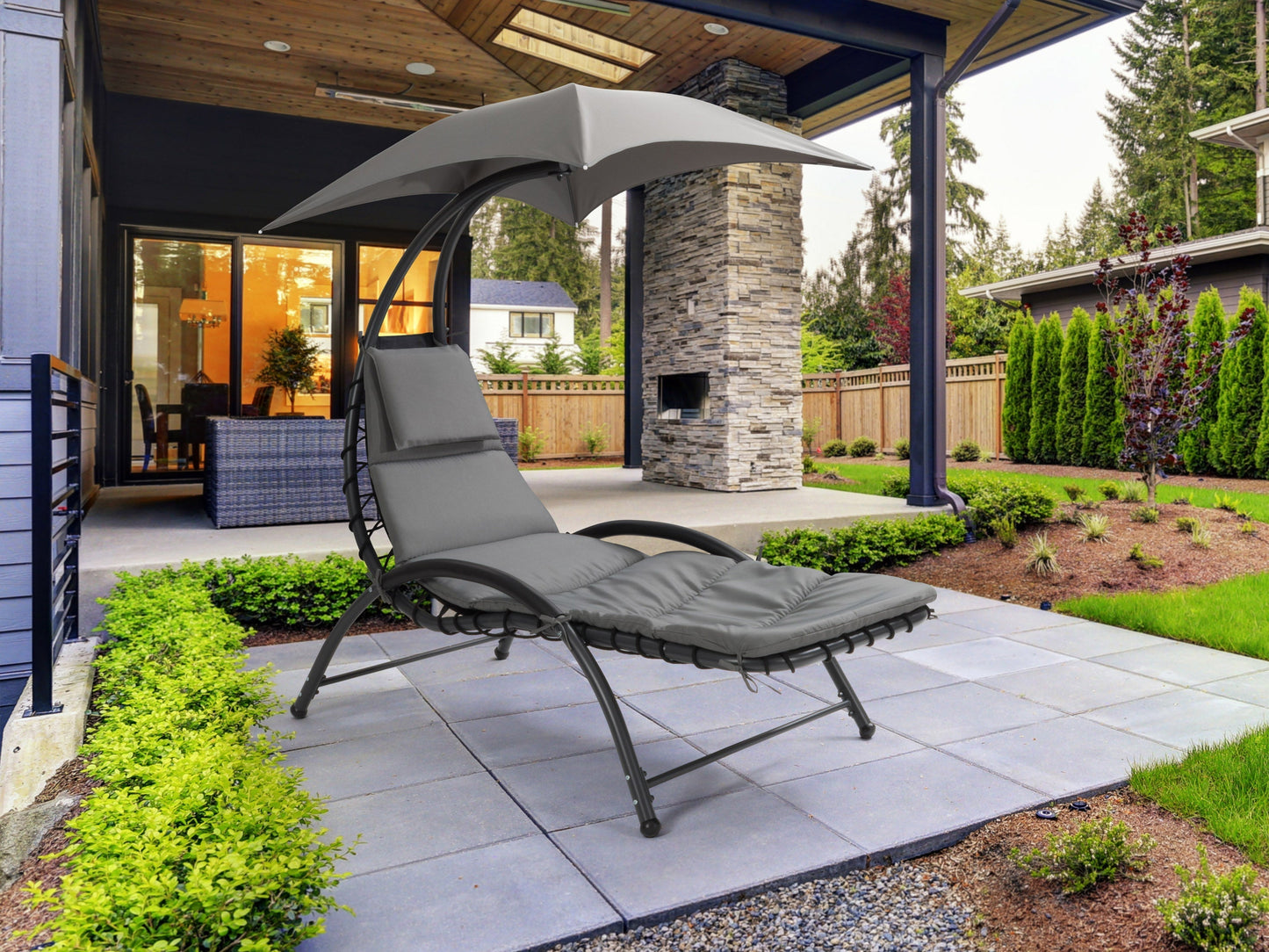 Grey patio lounge chair with canopy, cushioned seat, and sleek metal frame for outdoor relaxation.