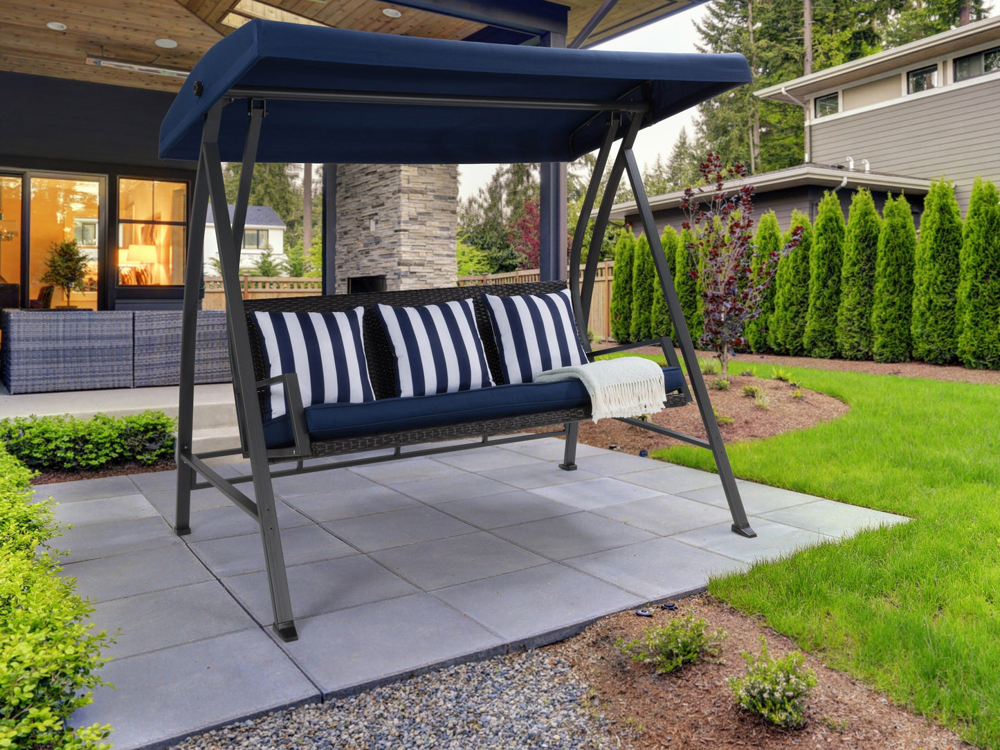 Navy blue patio swing with canopy, cushioned seats, and sturdy metal frame for outdoor relaxation.