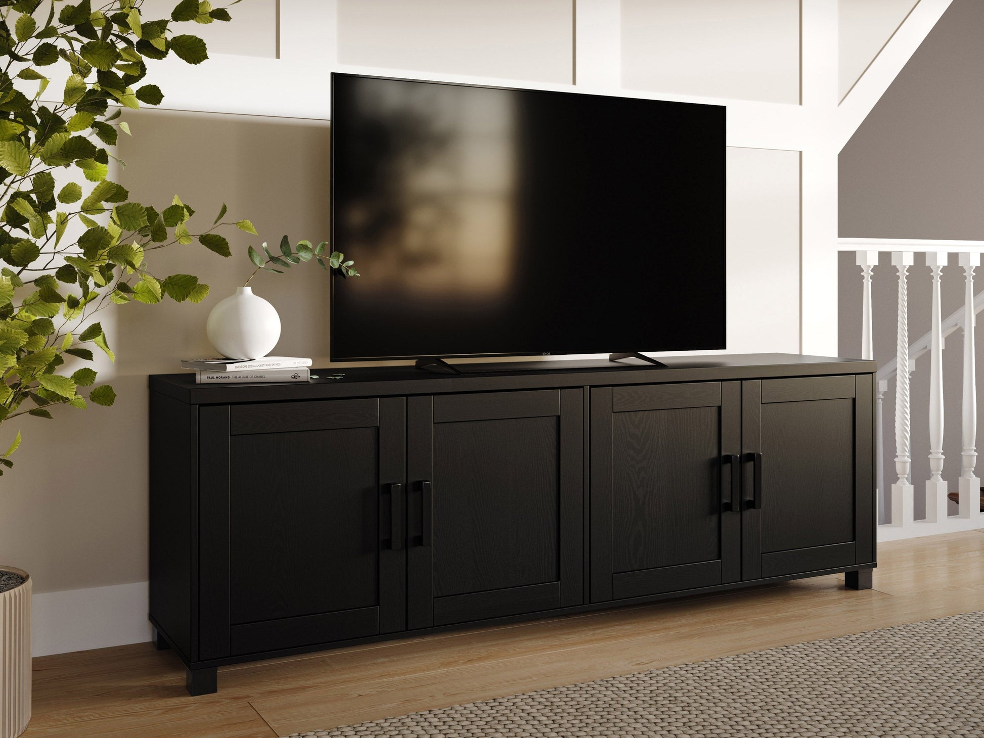 Black TV stand with doors, fits TVs up to 85 inches, sleek design, ample storage, modern entertainment center.