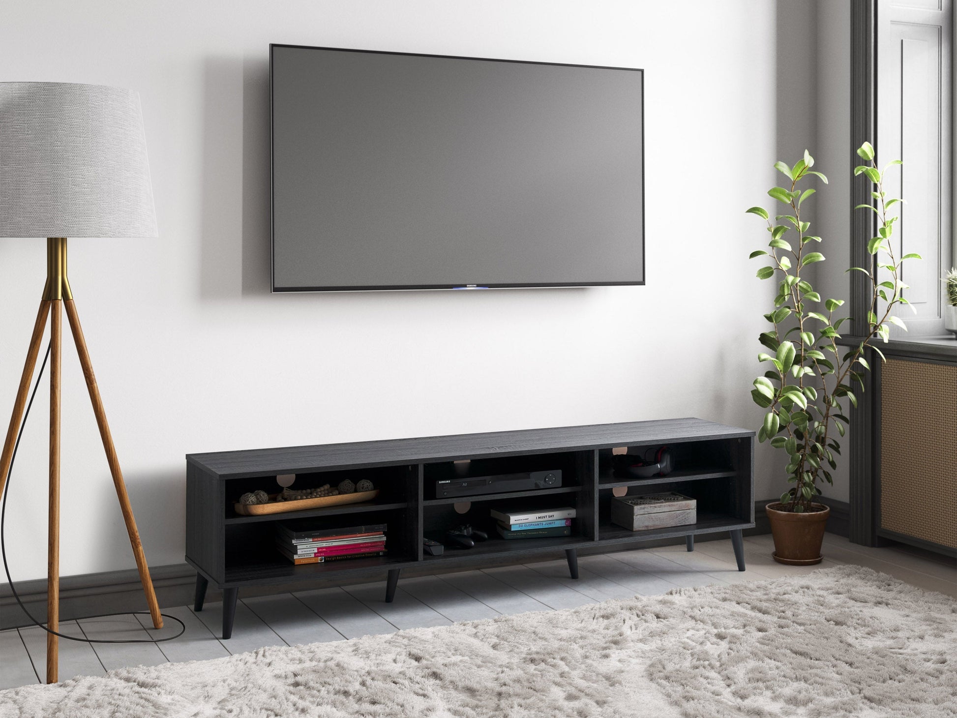 Dark grey TV stand with open shelves, supports TVs up to 85 inches, sleek modern design.