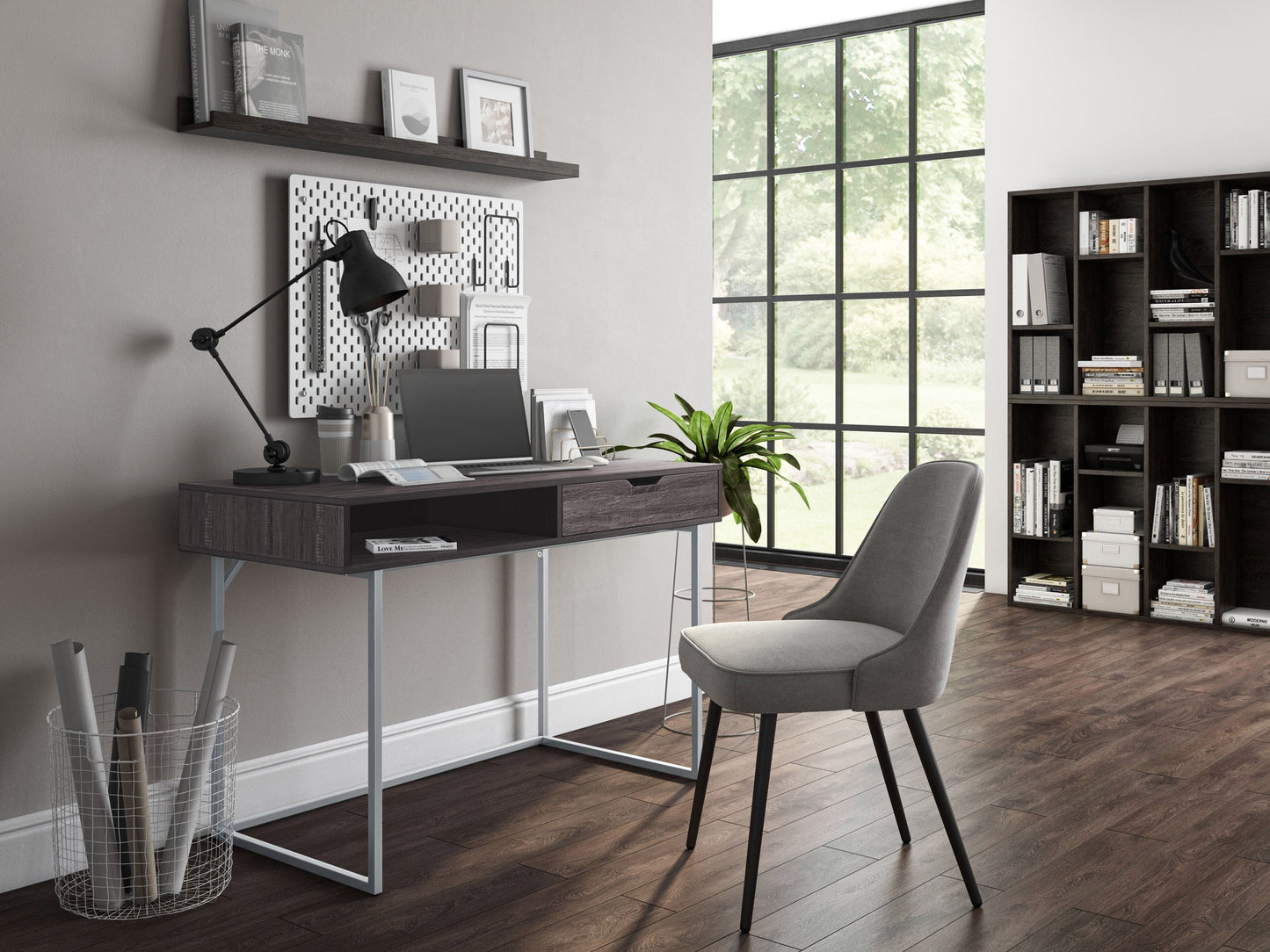 Modern grey computer desk with sleek metal legs and a spacious tabletop for home office use.