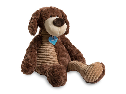 Alt text: Plush dog toy named Reggie with soft brown and white fur, floppy ears, and a black nose, sitting upright on a white surface.