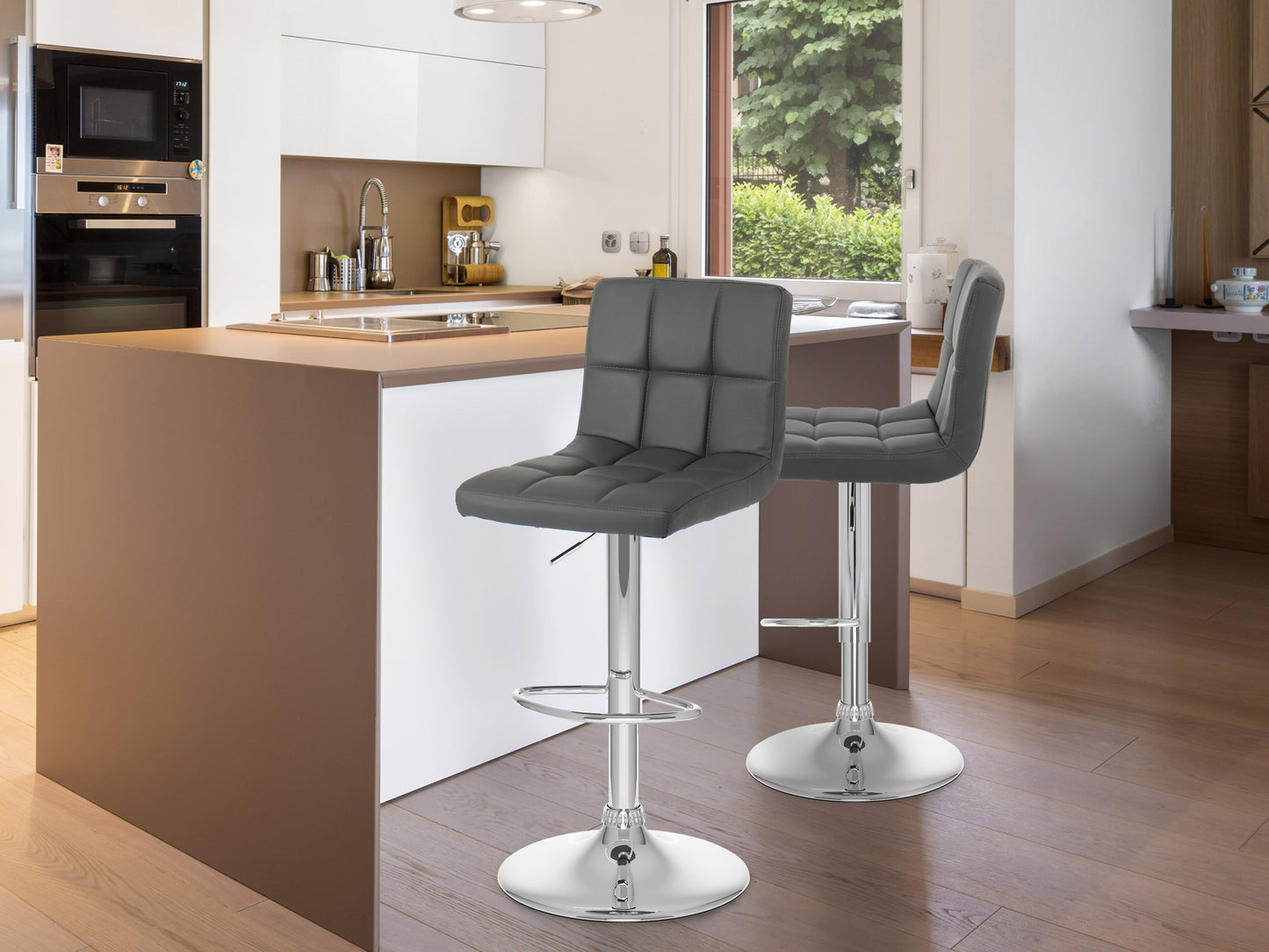 Modern black leather bar stool with chrome base and footrest, featuring a sleek design and adjustable height, placed in a contemporary kitchen setting with white cabinets and wooden flooring.