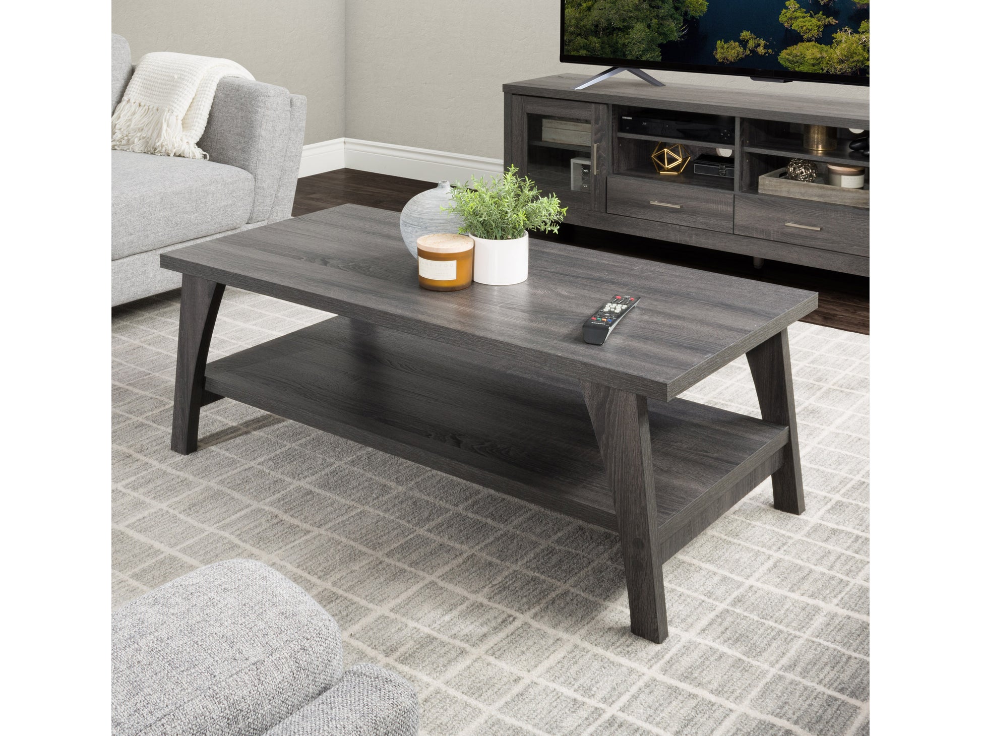 Two-tier coffee table with a sleek black metal frame, light wood finish, and open shelving design. Perfect for modern living rooms, providing ample storage and display space.