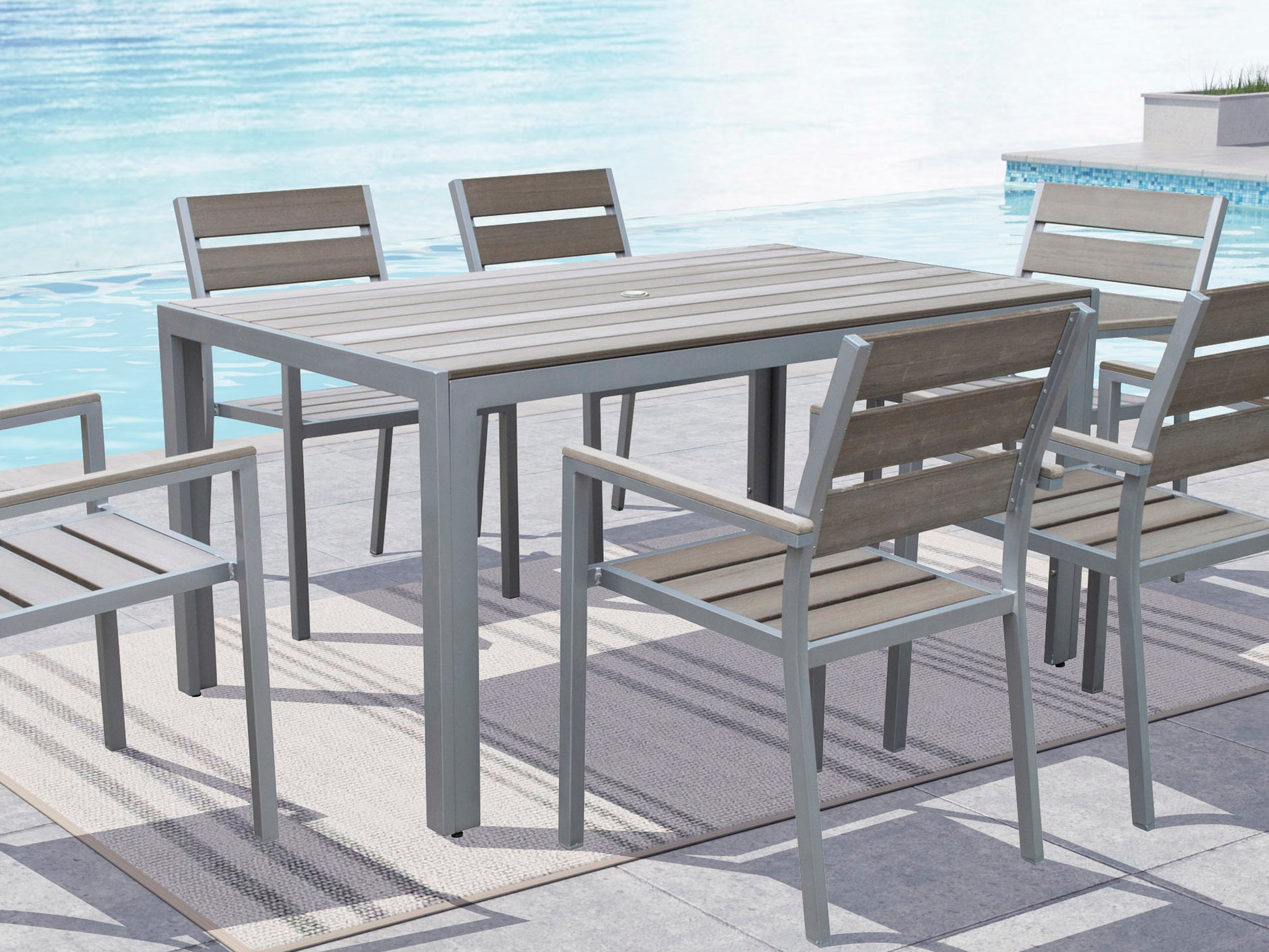 Modern rectangular outdoor dining table with light gray slatted aluminum top and dark gray metal legs, designed for patio use. Weather-resistant and ideal for outdoor gatherings.