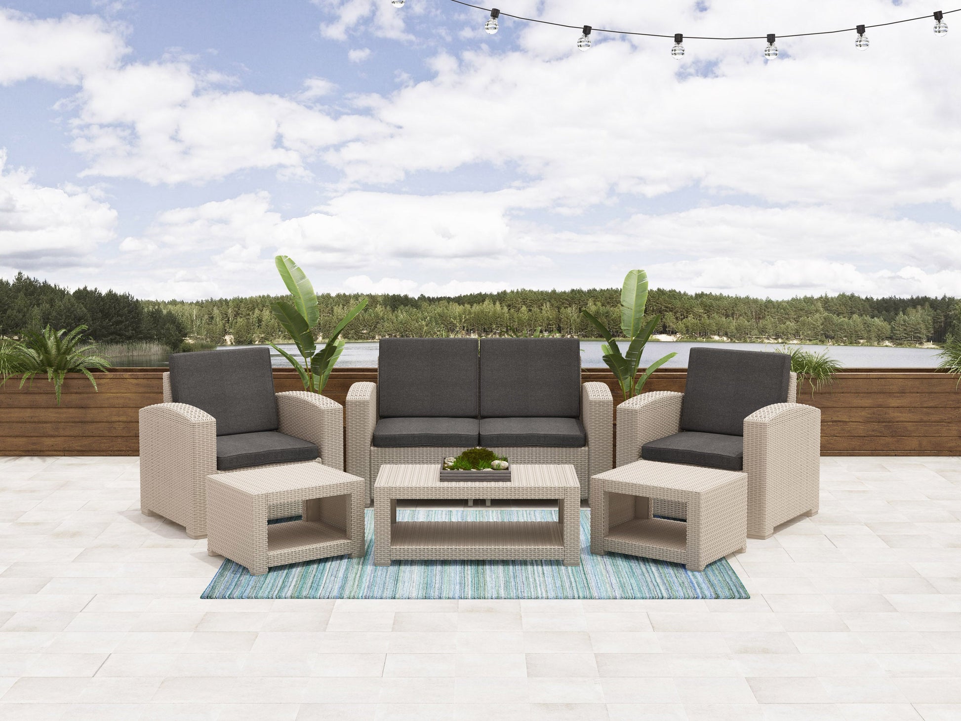 Gray wicker patio conversation set with cream cushions, featuring a glass-top coffee table, two armchairs, and a loveseat. Ideal for outdoor gatherings, offering comfort and style for any patio or garden setting.