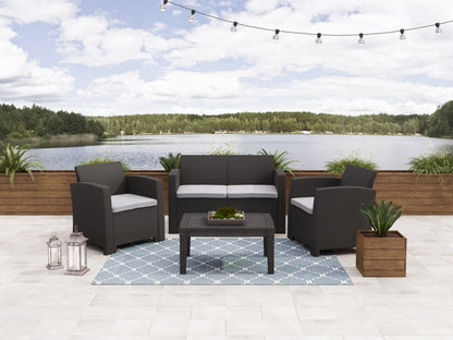 Modern patio conversation set with gray wicker, plush white cushions, and glass-top coffee table on outdoor deck. Ideal for stylish outdoor seating, combining comfort and durability for any patio or garden.