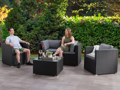 Outdoor patio conversation set, 5-piece, featuring a gray wicker sofa, two matching armchairs, and a glass-top coffee table with beige cushions, perfect for garden or deck lounging.